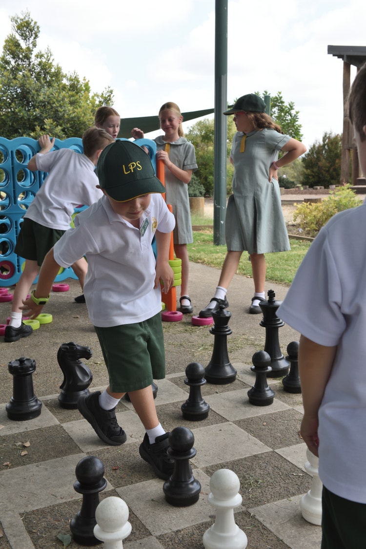Photo of students playing outdoor chess